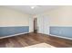 This bedroom features a large closet and stylish two-toned walls with wood-look floors at 3816 James Pl., Little River, SC 29566