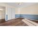 Bedroom showcases a ceiling fan, large closet, and stylish two-toned walls with wood-look floors at 3816 James Pl., Little River, SC 29566