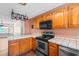 Well-equipped kitchen offering stainless steel appliances, wood cabinets, and generous counter space at 3816 James Pl., Little River, SC 29566