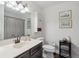 Well-lit bathroom featuring a dark vanity, white sink, and framed artwork on the wall at 4048 Sandtrap Ave., Little River, SC 29566