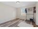 Bedroom with wood floors, a small stool on a rug, and a window at 4048 Sandtrap Ave., Little River, SC 29566