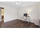 Bedroom with dark wood floors, and an office desk, perfect for a home office at 4048 Sandtrap Ave., Little River, SC 29566