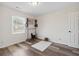 Bedroom with wood floors, a small stool on a rug, and a window at 4048 Sandtrap Ave., Little River, SC 29566