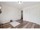 Bedroom with wood floors, an open door, closet, and a small stool on a rug at 4048 Sandtrap Ave., Little River, SC 29566