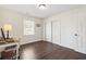 Bedroom with dark wood floors, sliding closet doors and an office desk at 4048 Sandtrap Ave., Little River, SC 29566