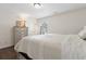 Bright bedroom featuring wood floors, a dresser, and a large window at 4048 Sandtrap Ave., Little River, SC 29566