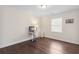 Bright bedroom featuring a small desk, hardwood floors, and a sun-filled window at 4048 Sandtrap Ave., Little River, SC 29566