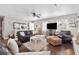 Cozy living room featuring hardwood floors, leather furniture, and natural light streaming through the windows at 4048 Sandtrap Ave., Little River, SC 29566