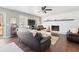 Bright living room featuring a fireplace, dark wood floors, comfortable leather furniture, and natural light at 4048 Sandtrap Ave., Little River, SC 29566