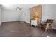 Spacious living room featuring hardwood floors, brick accent wall, and modern ceiling fan at 4048 Sandtrap Ave., Little River, SC 29566