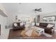 Open living room featuring hardwood floors, fireplace, and view into the bright kitchen at 4048 Sandtrap Ave., Little River, SC 29566