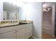 Bathroom featuring granite countertops, white cabinets, a large mirror, and a shower with bathtub at 4339 Dew N. Ct., Myrtle Beach, SC 29579