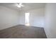 A well-lit bedroom with neutral walls, plush carpeting, a ceiling fan, and an open doorway leading to the bathroom at 4339 Dew N. Ct., Myrtle Beach, SC 29579