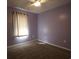 This bedroom offers carpet, light purple walls, a ceiling fan, and a window with light-filtering curtains at 4339 Dew N. Ct., Myrtle Beach, SC 29579