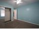 A cozy bedroom painted blue featuring carpeted floors, a ceiling fan, and a mirrored sliding closet door at 4339 Dew N. Ct., Myrtle Beach, SC 29579