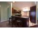 Kitchen with a breakfast bar features dark wood cabinetry and stylish black and white flooring at 4339 Dew N. Ct., Myrtle Beach, SC 29579