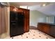 Open concept kitchen features a black refrigerator and wood cabinets, offering easy access to the living area at 4339 Dew N. Ct., Myrtle Beach, SC 29579