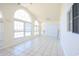 Bright living room with tile floors, high vaulted ceiling, many windows and sliding glass door to the backyard at 4339 Dew N. Ct., Myrtle Beach, SC 29579