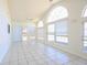 Bright living room with tile floors, high vaulted ceiling, many windows and sliding glass door to the backyard at 4339 Dew N. Ct., Myrtle Beach, SC 29579