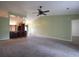 Bright living room showcases a ceiling fan and access to the kitchen area with bar seating at 4339 Dew N. Ct., Myrtle Beach, SC 29579