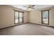 Spacious bedroom with neutral carpet, two windows and ceiling fan at 4494 Little River Inn Ln. # 2301, Little River, SC 29566