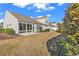 Backyard with sunroom, grass, and vegetation at 5027 Prato Loop, Myrtle Beach, SC 29579