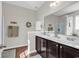 Well-lit bathroom with dark wood cabinets, white countertop and neutral paint at 5027 Prato Loop, Myrtle Beach, SC 29579