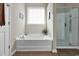 Bathroom with large soaking tub and glass enclosed shower at 5027 Prato Loop, Myrtle Beach, SC 29579