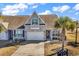 Charming home with a well-manicured lawn, tan brick, and an attached two-car garage at 5027 Prato Loop, Myrtle Beach, SC 29579