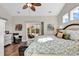 Vaulted ceiling primary bedroom features sliding doors to an outdoor patio at 5027 Prato Loop, Myrtle Beach, SC 29579