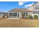 A view of the sunroom and outdoor patio, showcasing a relaxing extension to the home with natural lighting at 5027 Prato Loop, Myrtle Beach, SC 29579