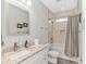 Bathroom features modern vanity, sink, and a shower-tub combination with marble-look tile surround at 518 Harbour View Dr., Myrtle Beach, SC 29579