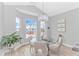 Cozy dining area with a glass-top table, chandelier, and bright natural light at 518 Harbour View Dr., Myrtle Beach, SC 29579