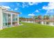 Backyard with pond view featuring manicured lawn and vibrant landscaping at 560 Pier Ct., Longs, SC 29568