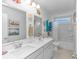 Bright bathroom featuring dual sinks, neutral flooring, a combined shower and tub and decorative fish at 560 Pier Ct., Longs, SC 29568