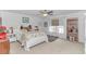 Bright bedroom featuring a plush bed with white comforter, fan, and natural light from the window at 560 Pier Ct., Longs, SC 29568