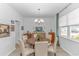 Elegant dining room with hardwood floors, round wood table, and a window with natural light and neutral decor at 560 Pier Ct., Longs, SC 29568