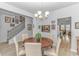 Cozy dining area next to the staircase features a round table, six chairs and hardwood floors at 560 Pier Ct., Longs, SC 29568