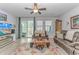 Cozy living room with leather sofas, decorative rug, entertainment center, and views of the outdoors at 560 Pier Ct., Longs, SC 29568