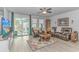 Comfortable living room with leather furniture, ceiling fan, and sliding door to a patio at 560 Pier Ct., Longs, SC 29568