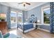 Inviting bedroom with blue accents, wood floors, two windows, and a decorative wrought-iron headboard at 587 Starlit Way, Myrtle Beach, SC 29579