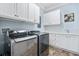 Bright laundry room features modern washer/dryer, ample white cabinets, and a convenient utility sink at 587 Starlit Way, Myrtle Beach, SC 29579