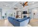 Bright living room with fireplace, coffered ceilings, and stylish blue sectional couch at 587 Starlit Way, Myrtle Beach, SC 29579