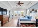 Serene main bedroom with tray ceiling, ample natural light, and hardwood floors at 587 Starlit Way, Myrtle Beach, SC 29579