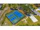 Aerial view of well-maintained community tennis and pickleball courts, surrounded by trees at 587 Starlit Way, Myrtle Beach, SC 29579