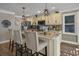 Kitchen island boasts marble countertops, seating, and pendant lighting at 6001-0917 S Ocean Blvd., Myrtle Beach, SC 29575