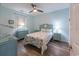 Bright bedroom featuring light-colored wooden floors, a dresser and a large seashell headboard at 601 Hillside Dr. N # 3736, North Myrtle Beach, SC 29582