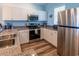 The renovated kitchen is equipped with stainless steel appliances and granite countertops at 601 Hillside Dr. N # 3736, North Myrtle Beach, SC 29582