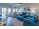 Comfortable coastal-themed living room with a blue sofa and sliding door access to a porch at 601 Hillside Dr. N # 3736, North Myrtle Beach, SC 29582