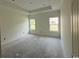 Bedroom featuring neutral walls, base trim, two bright windows and tray ceiling at 6049 Hodges Rd., Conway, SC 29527